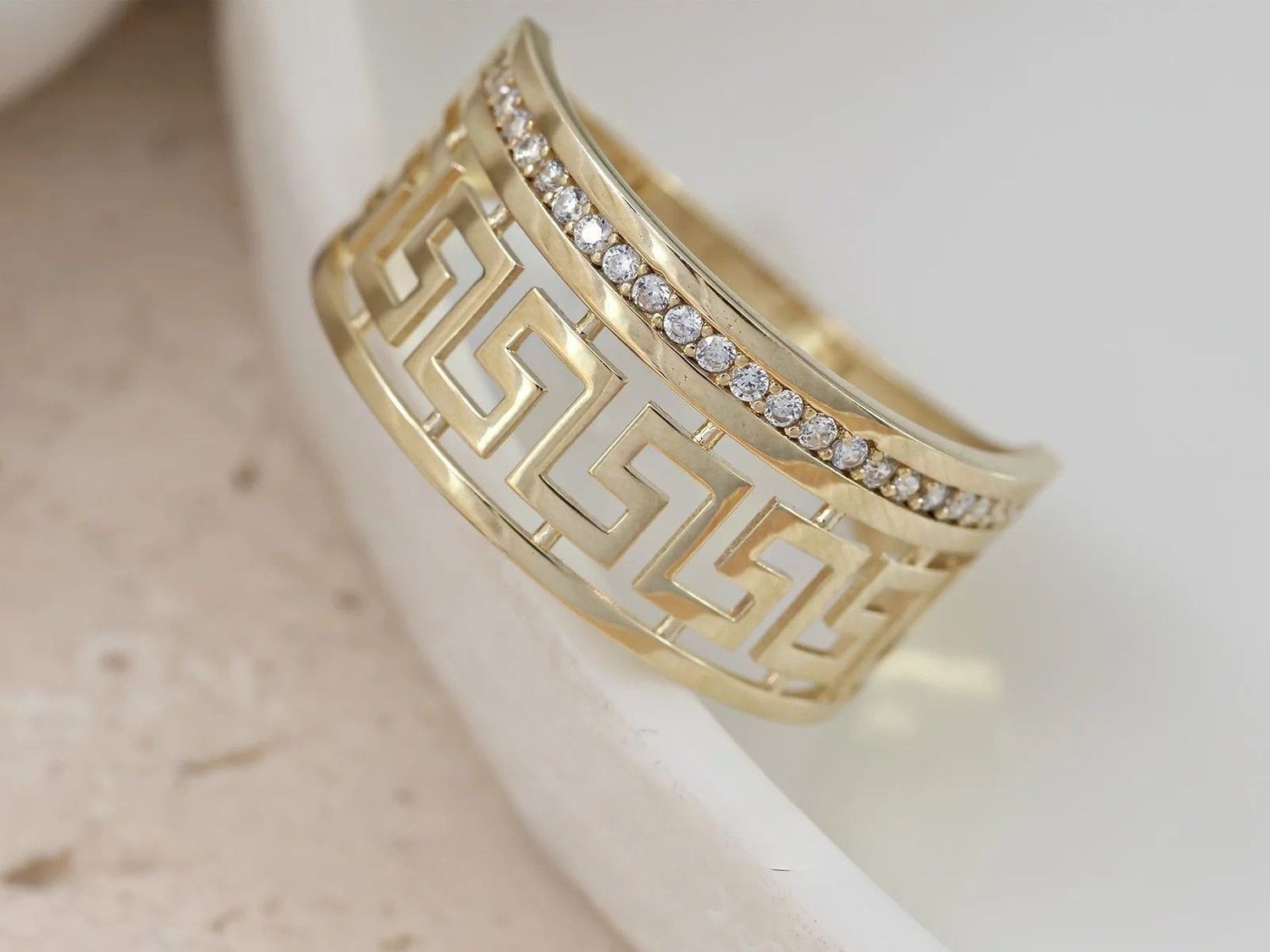 Elegancki pierścionek damski z żółtego złota próby 375, wysadzany cyrkoniami, z motywem greckim. Okazały, błyszczący pierścionek z kolekcji Ornament – idealny na prezent.1.jpg